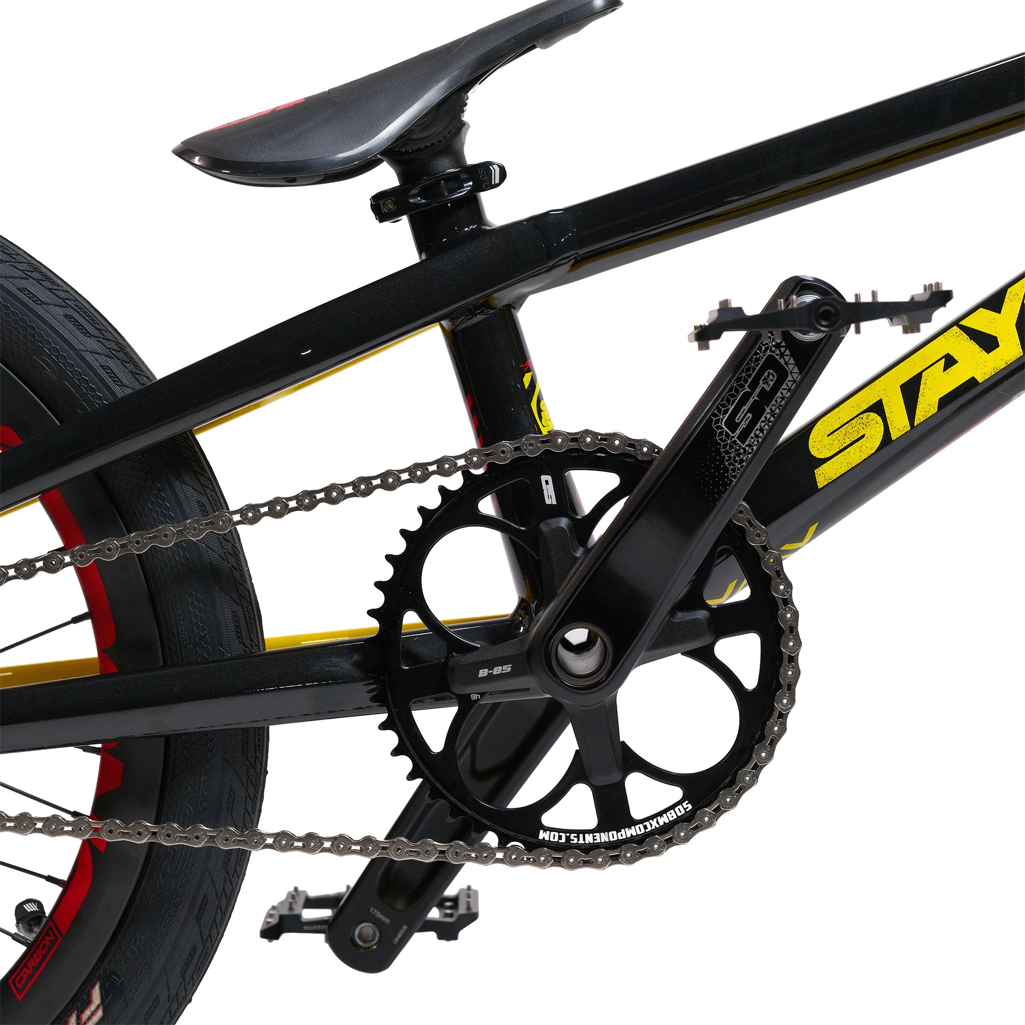 Close-up of a black bicycle's rear wheel, chain, crankset, and seat post, highlighting part of the yellow "STAY" logo on the frame. This detailed shot showcases the quality construction typical of custom race bikes and the durability of aluminium frames, as featured on the Stay Strong V5.1 Pro XXXL Race Bike.