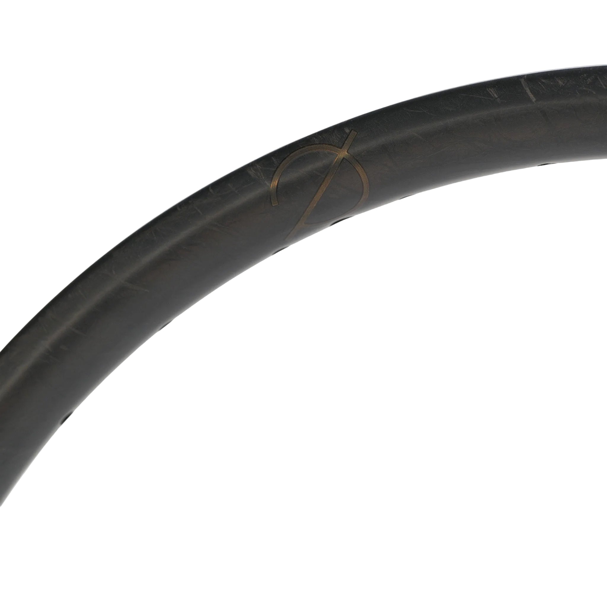 Close-up of a dark, Spectre V3 Lite Carbon Fiber 20 Inch 36H Brakeless Rim with a subtle logo against a plain white background, highlighting the lightweight carbon fiber construction.