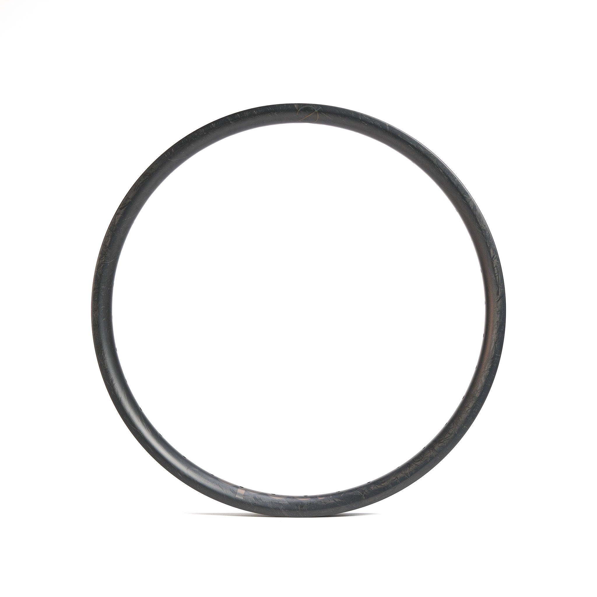 A single, dark-colored circular ring or hoop—resembling the sleek profile of a Spectre V3 Lite Carbon Fiber 20 Inch 36H Brakeless Rim—is centered on a plain white background.