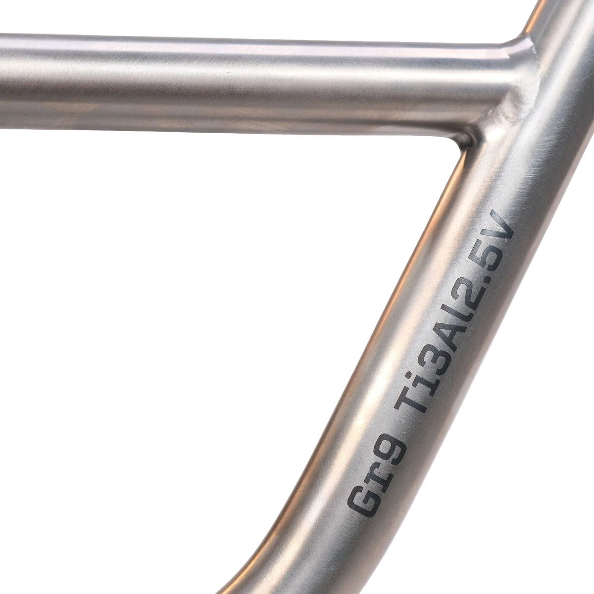 Close-up of the metallic frame of the ION BMX Ti16 Custom Titanium 16 Inch Bike, with “Gr9 Ti3Al2.5V” engraved on the tube, indicating the titanium alloy composition of this lightweight BMX.