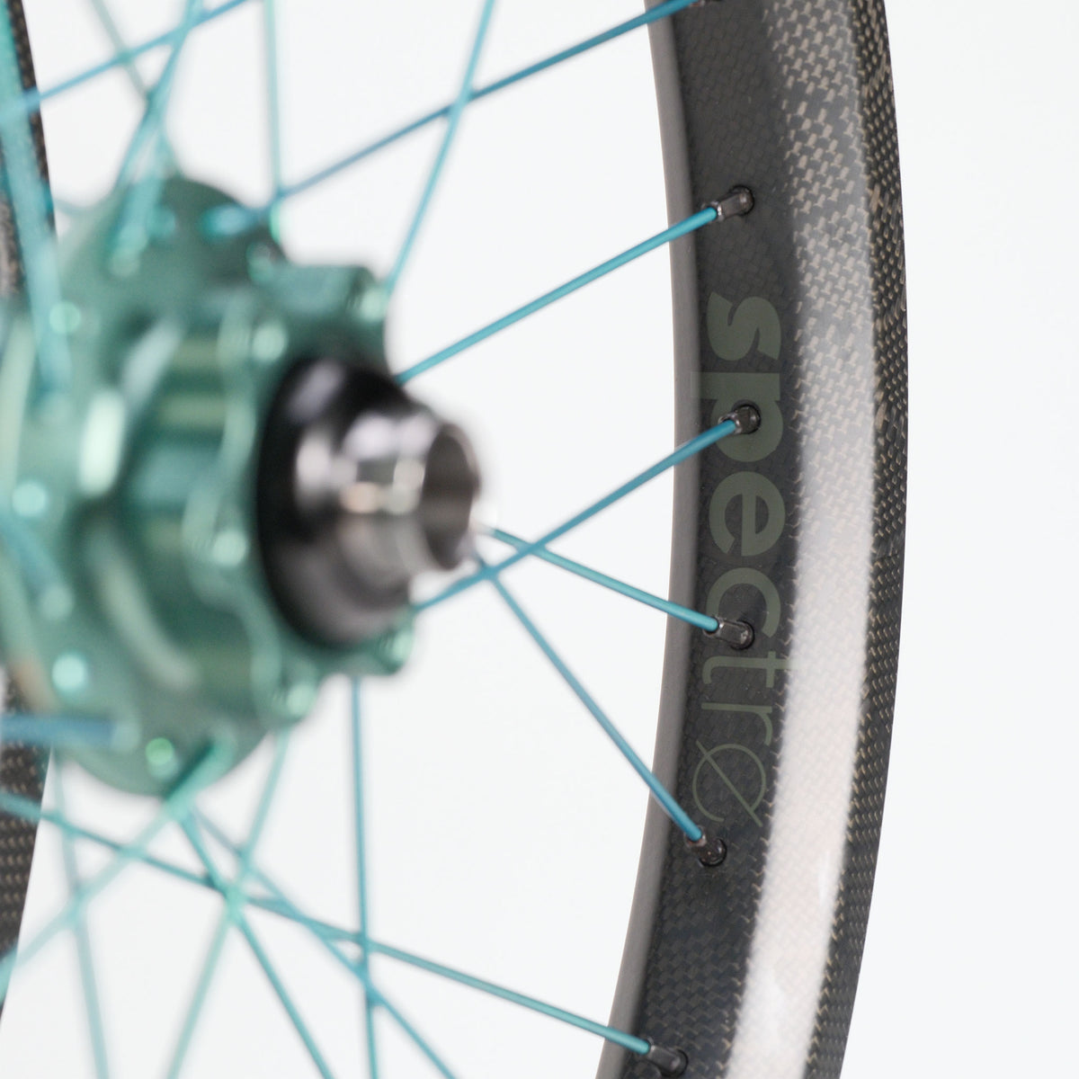 Chris King X Spectre NME Custom 20inch Wheel Set carbon fiber BMX race wheels featuring teal spokes and a matching teal hub.