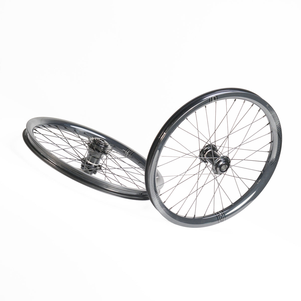Two black 20-inch SD-X Sniper Evo Pro x SD-X M58 V2 bicycle wheels with spokes and center hubs, angled against each other on a white background.