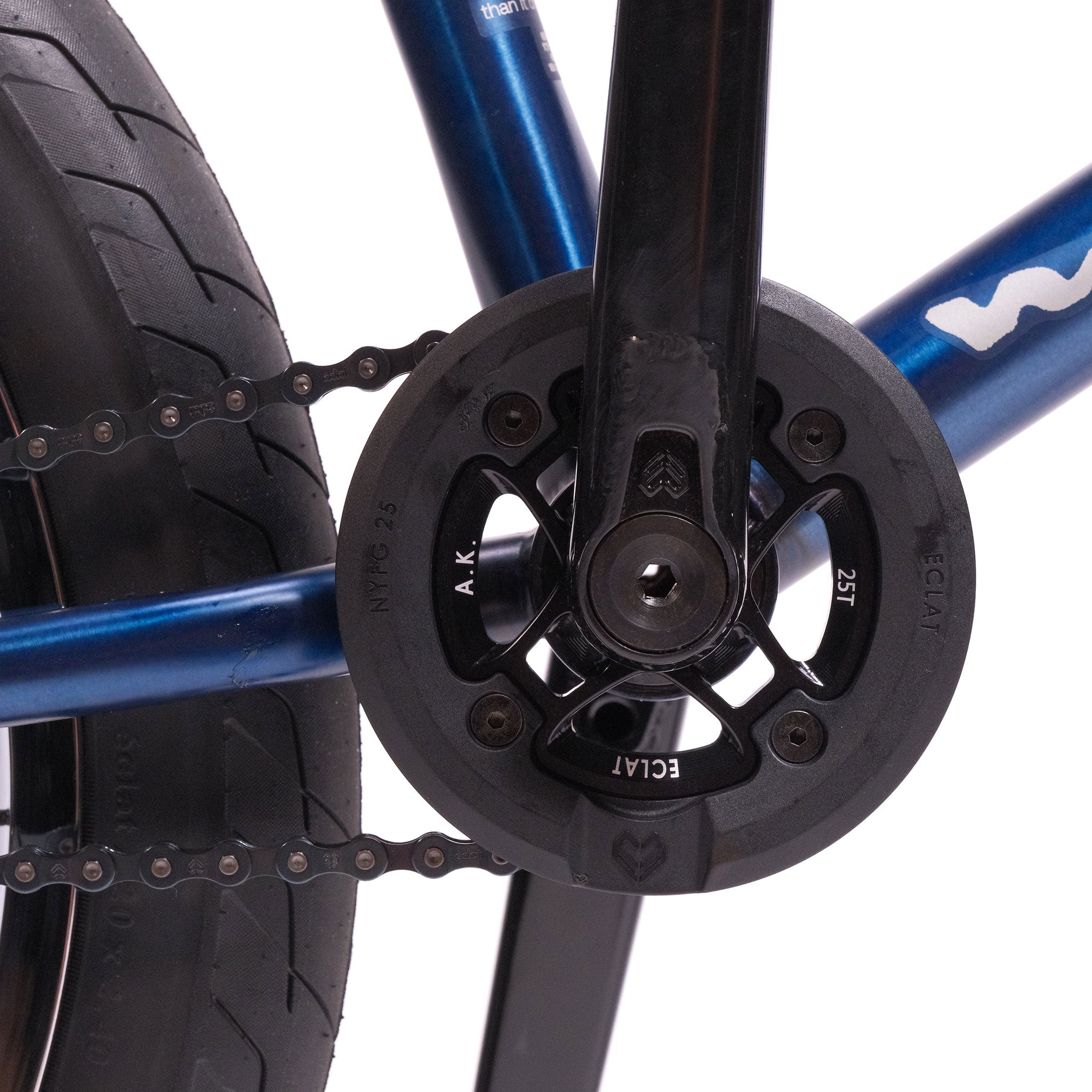 Close-up of the Wethepeople Tomorrow X TA Custom build featuring a black Eclat chainring, visible chain, and part of the blue frame and rear tire.