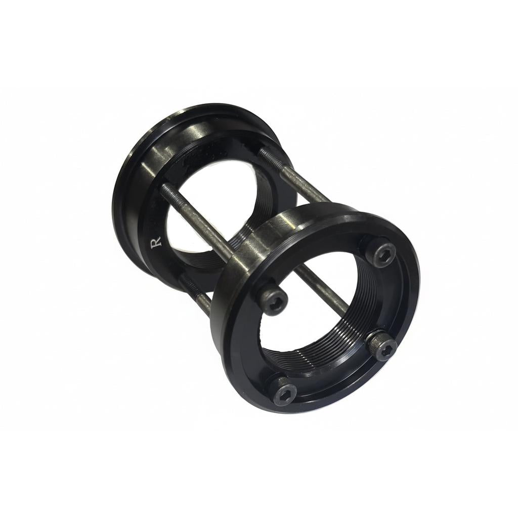A USA to BSA Bottom Bracket Conversion Kit, featuring black metal threaded euro BB cups connected by bolts and spacers, is shown against a white background.