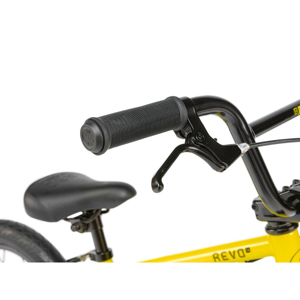 Close-up of the black handlebar with brake lever and grip from the Radio Revo 14 Inch bike; shows part of its yellow frame and black saddle—perfect as a first BMX for young riders.