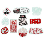 The BSD 2024 Sticker Pack (10 Pack) features ten vinyl stickers with assorted BSD designs, including text, a van, cassette tape, and bold red, black, and white graphics.