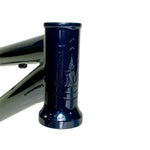 Close-up of the S&M Big Jumper V2 26 Inch dirt jumper frame's dark blue head tube with embossed logo, isolated on a white background.