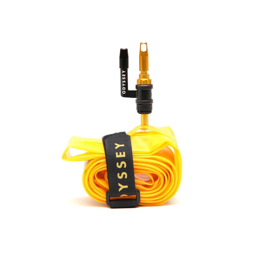 The Odyssey OPTIS Insert With Valve P/V Tube (29 Inch) is a yellow rolled inner tube with a black “Odyssey” strap and gold Presta valve—perfect for boosting bike tire performance and dependable rim protection.