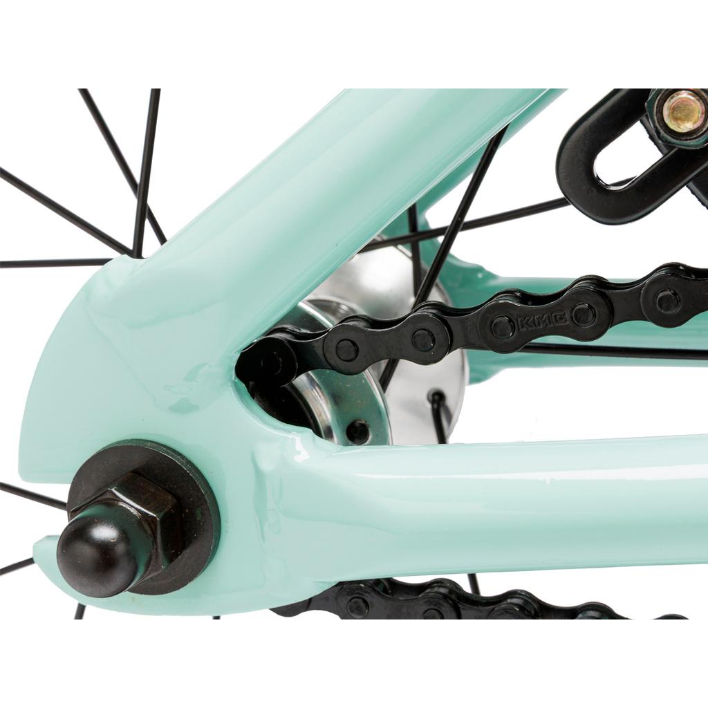 Close-up of the Fit Misfit 12 Inch Bike's rear dropout, showing the chain, axle nut, and mint green frame.