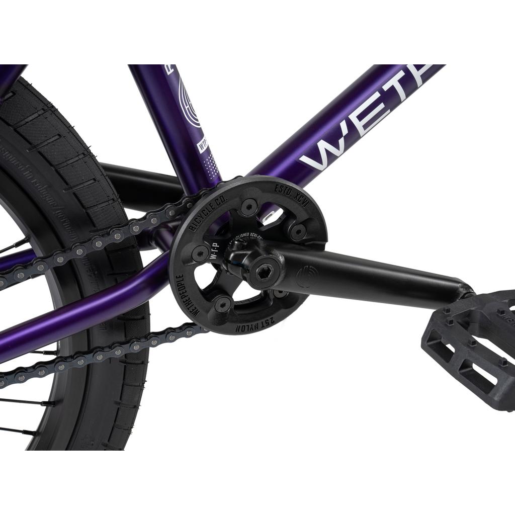 Close-up of the Wethepeople Reason Shift 20 Inch Bike's drivetrain, showcasing its full chromoly crankset, chain, sprocket, and pedal on the rear section with a freecoaster cassette hybrid.