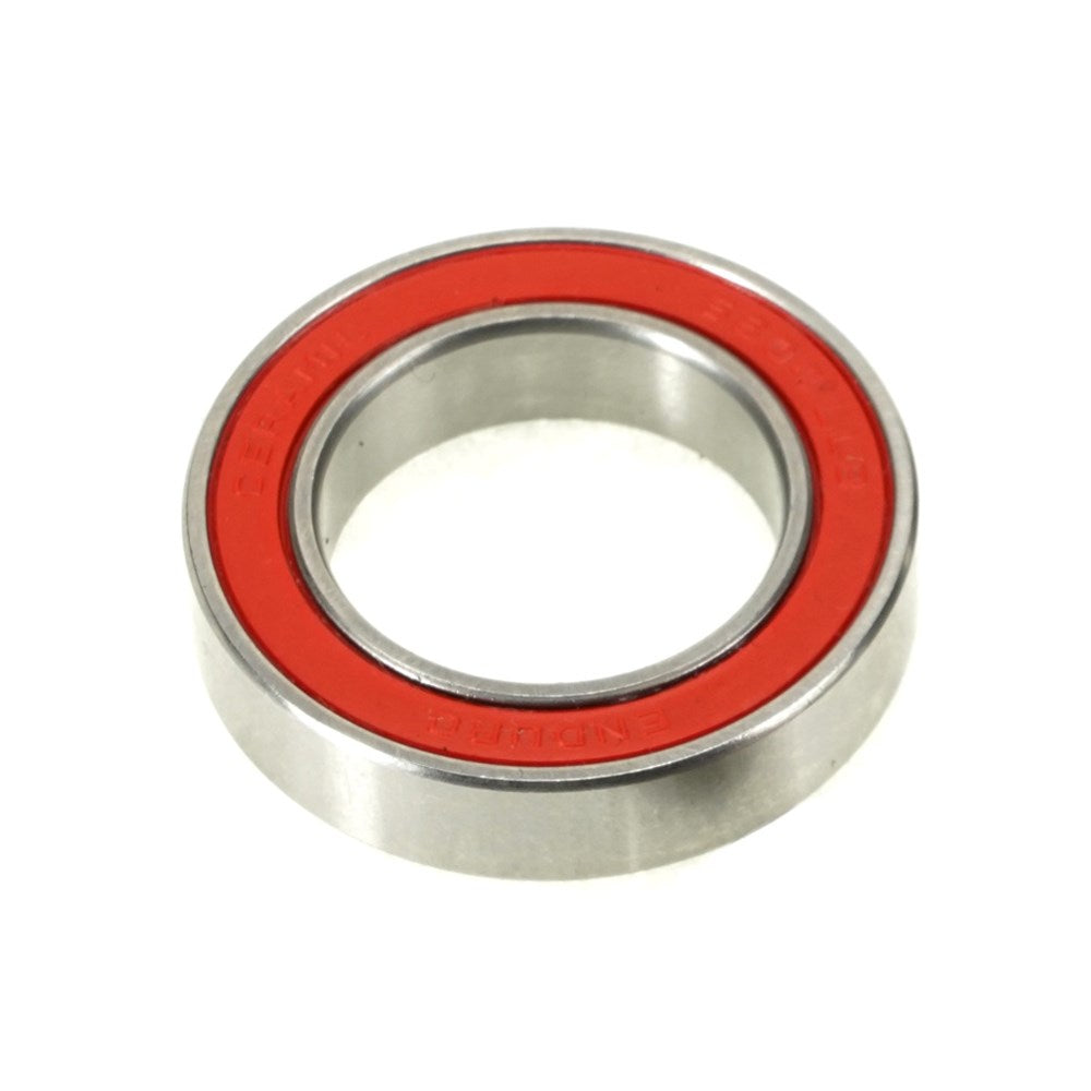 The Enduro A5 LLB Ceramic Hybrid Radial Sealed Bearing (each) is a deep-groove ABEC-5 bearing with a red seal on one side, shown against a white background.