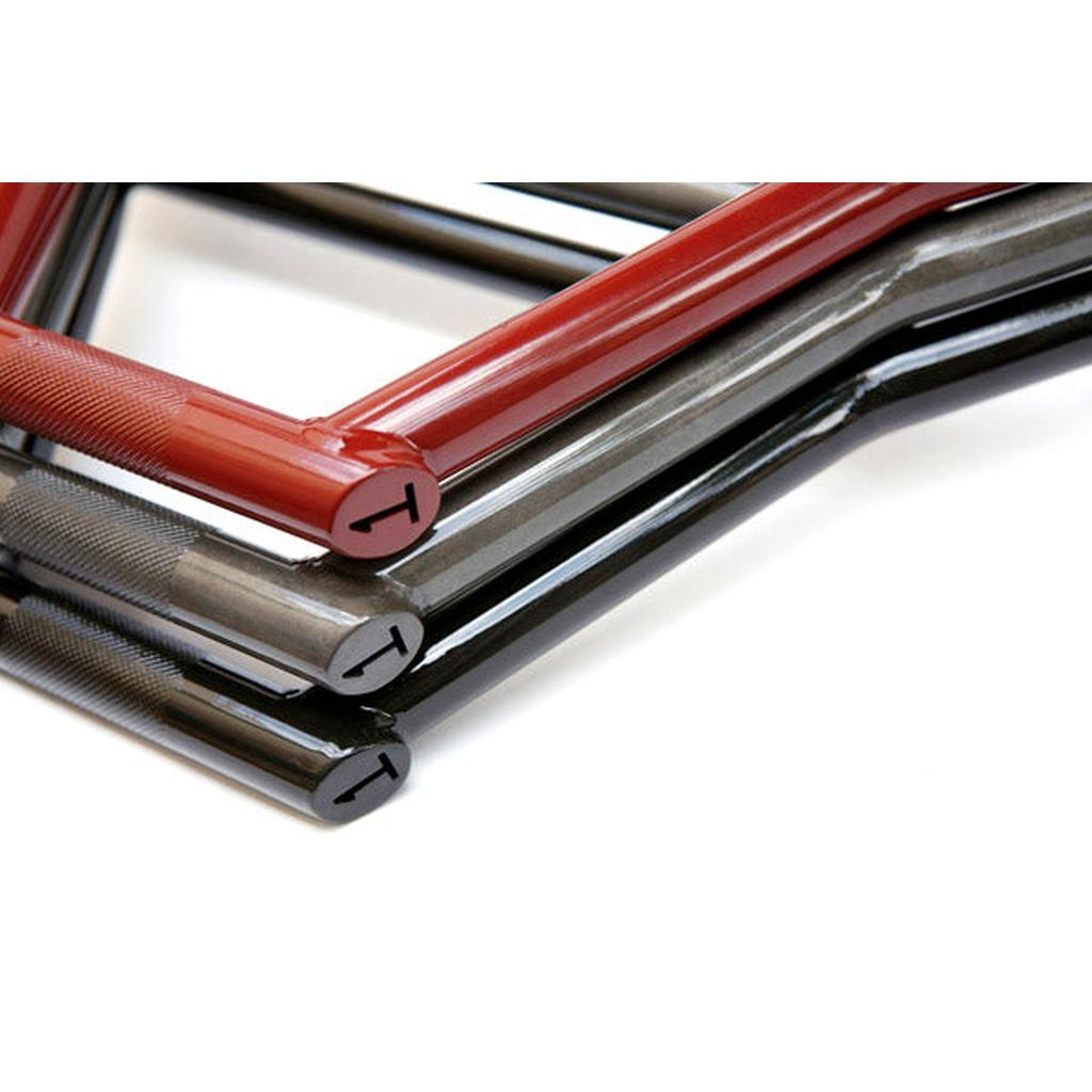 Close-up of three Terrible One 2024 Elf Bars—hexagonal metal handles resembling BMX handlebars, two black and one red, each engraved with a "T" on the end.
