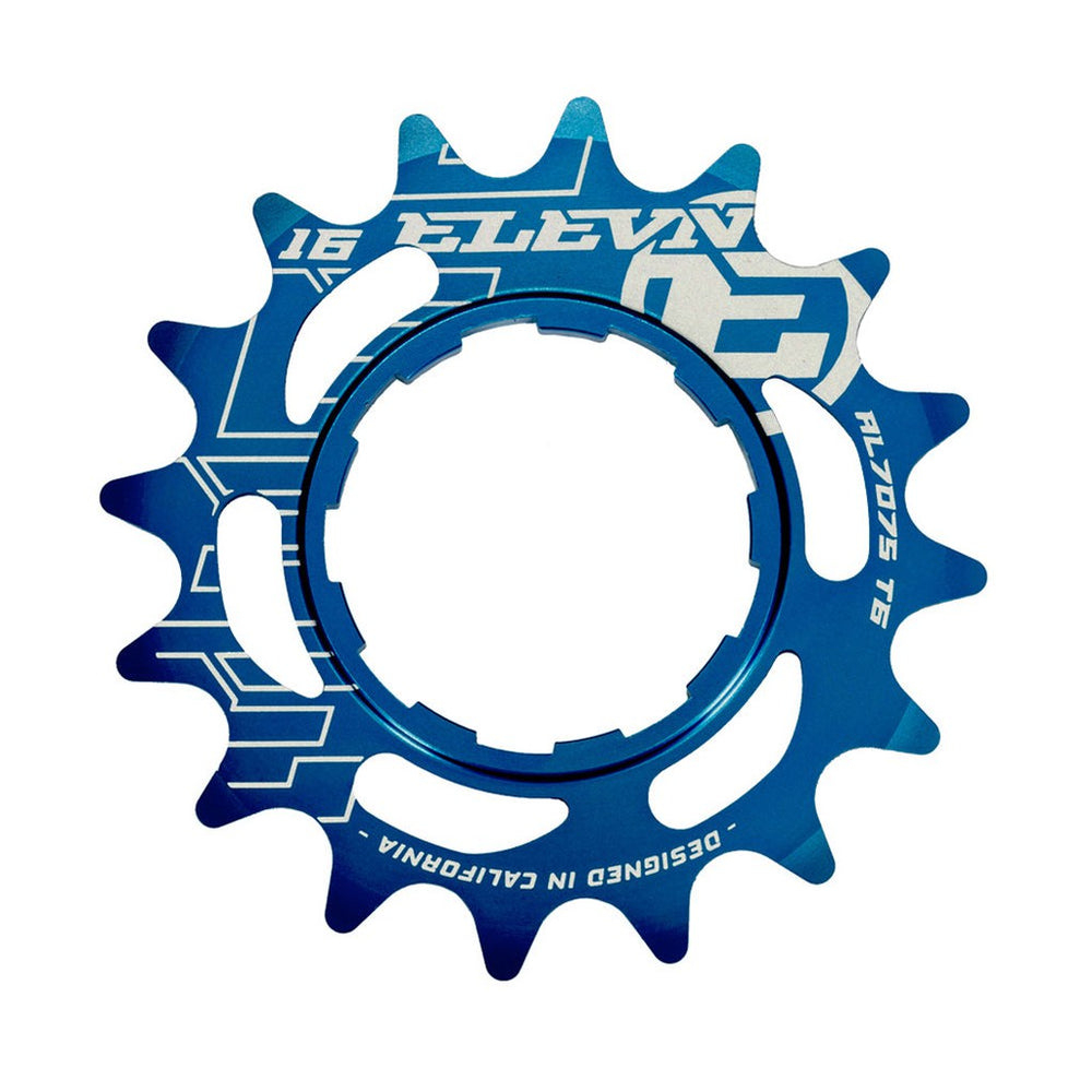 Blue anodized Elevn Alloy Cog 3/32 Shimano Comp bicycle chainring with engraved text and numbers, isolated on a white background.
