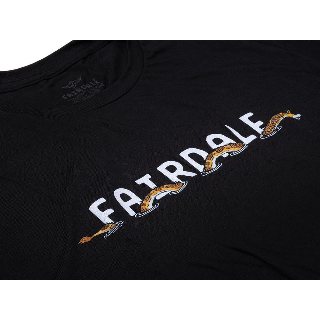 Black tee featuring "FAIRDALE" with a tiger leaping through the letters, inspired by the Fairdale x Vans Taj Cruiser collection. Product: Fairdale Giraffeness Monster T-Shirt.
