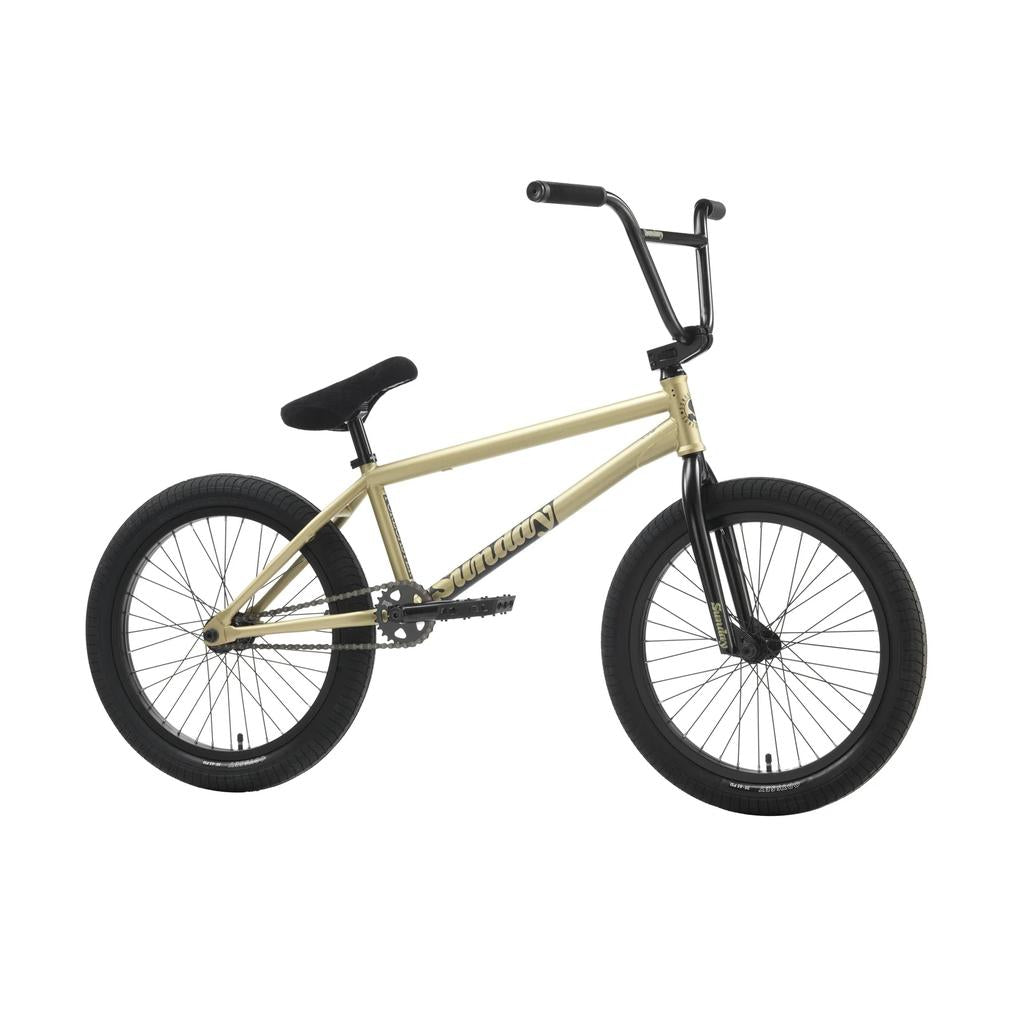 The Sunday Forecaster 20 Inch Bike (2025) / Broc Raiford is a tan and black BMX with thick tires, a padded seat, straight top tube, and full chromoly frame, shown in profile on a white background.