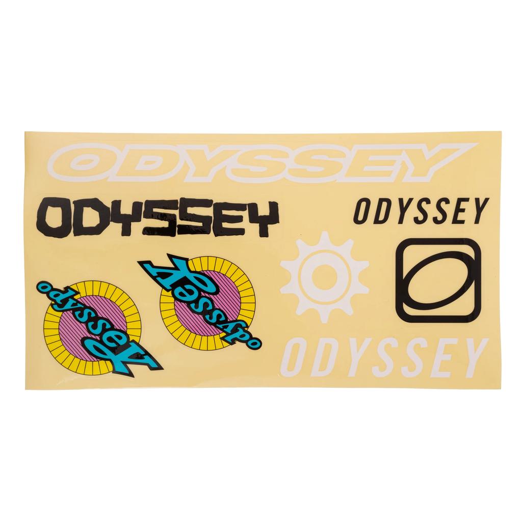 A sheet from the Odyssey 40th Anniversary Retro Sticker Pack with assorted 80's throwback stickers in various fonts, colors, and designs displayed on a yellow background.