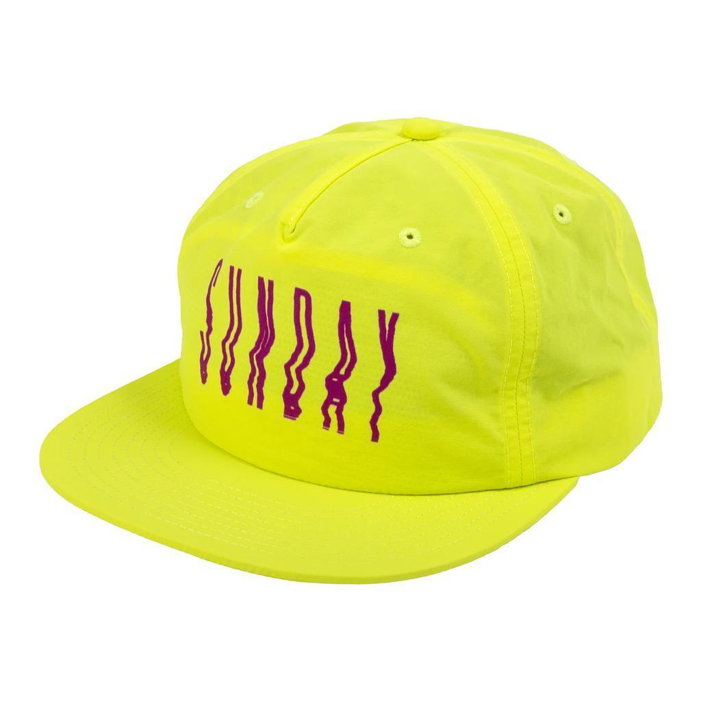 The Sunday High Wave Cap is a bright yellow snapback with purple, wavy vertical "SUNDAY" text on the front—ideal for Sunday Caps or your Back to School 2025 collection.