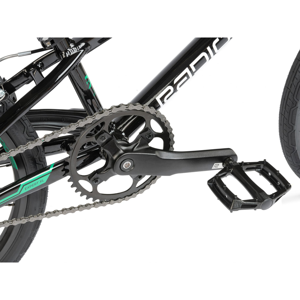 A black and green Radio Xenon Expert XL BMX race bike with a chain and gears.