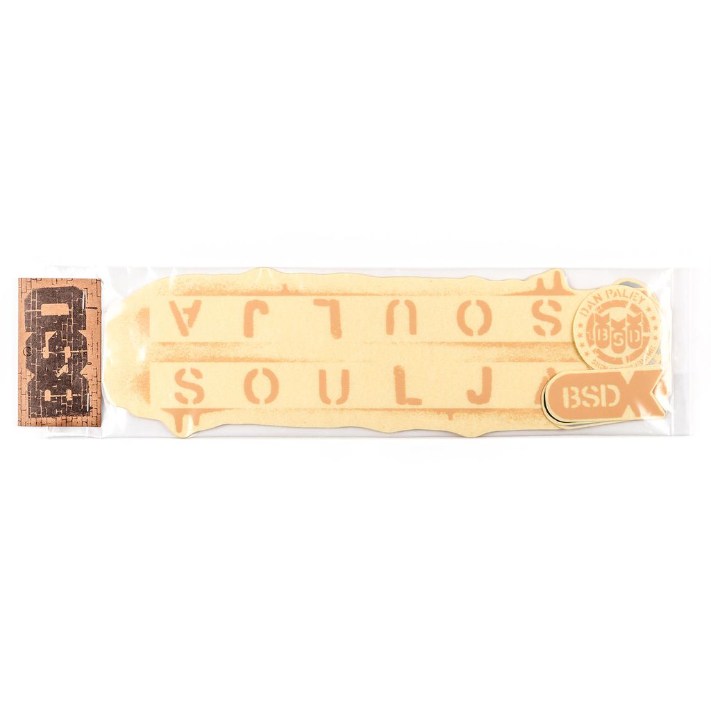 The BSD Soulja Frame 2019 Decal Set includes a packaged sticker sheet showcasing tan and orange designs with the text "SOULJA," along with an attached rectangular label that features intricate patterns, ideal for enhancing your Soulja frame.