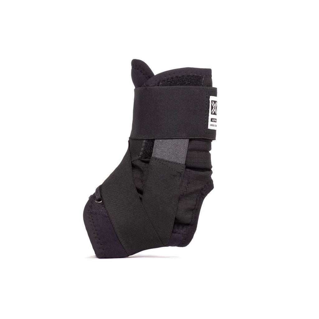 The Fuse Alpha Pro Ankle Brace (Pair) in black, designed with reinforced straps and crafted from anti-bacterial neoprene, featuring a Velcro closure, is displayed upright on a white background.