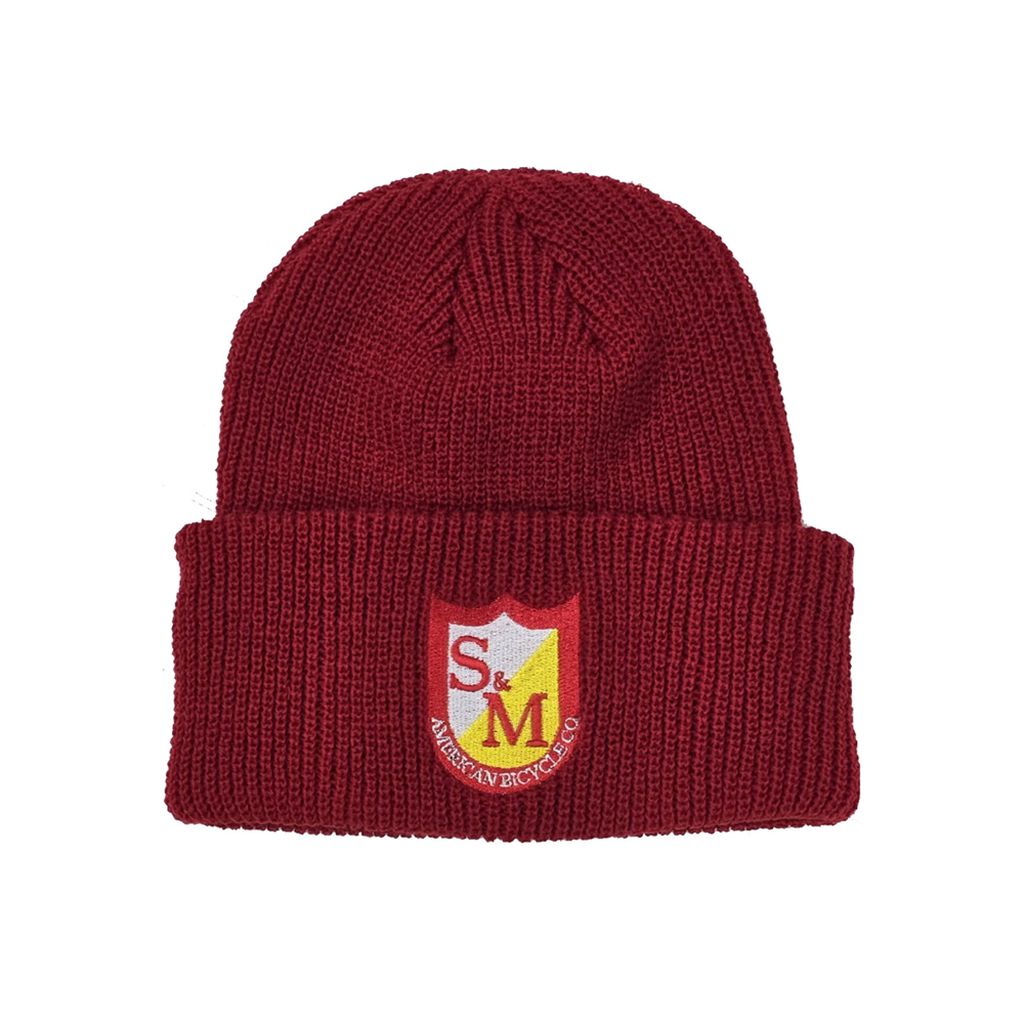 A maroon ribbed cuffed beanie featuring an embroidered red and yellow crest with the letters "S&M" and the text "Museum in Chicago.