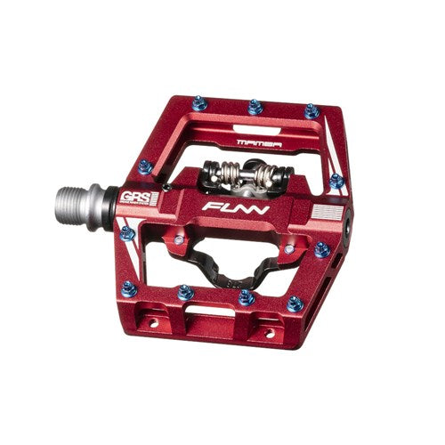 The Funn Mamba S SPD Pedals, in red, are ideal for enduro racing with their flat platform design, metal studs, and silver axle, ensuring reliable performance on every ride.