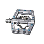 Close-up of a metal bicycle pedal with an open design, featuring blue screws and labeled "Funn Mamba S SPD," perfect for enduro racing.