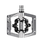 The Funn Mamba S SPD Pedal (Small Platform) is a silver, metal-framed bike pedal with a clipless mechanism, ideal for enduro racing. It features the brand name "Funn" and "Mamba," compatible with Shimano SPD systems, and offers replaceable axle kits.