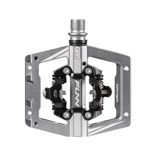 The Funn Mamba S SPD Pedal (Small Platform) is a silver, metal-framed bike pedal with a clipless mechanism, ideal for enduro racing. It features the brand name "Funn" and "Mamba," compatible with Shimano SPD systems, and offers replaceable axle kits.