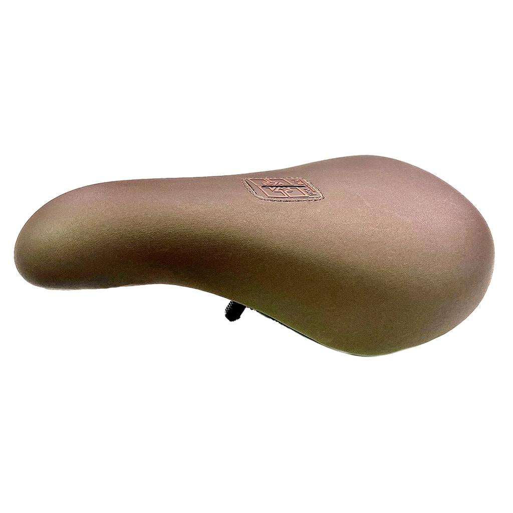 The Fit Barstool Pivotal Seat is a brown padded bicycle seat with a stitched emblem on top, featuring a contoured barstool design, displayed against a plain white background.