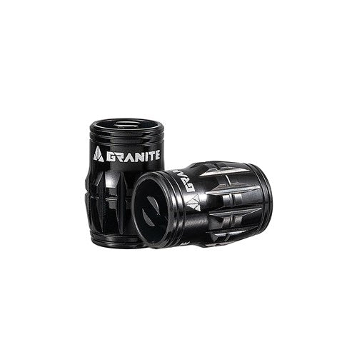 The Granite Juicy Valve Caps feature a black cylindrical design with textured grips and the "Granite" logo. Ideal for tubeless setups, they come in a pair and include a valve core remover for precise on-the-go adjustments.