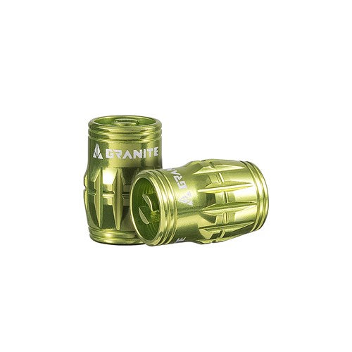 Two Granite Juicy Valve Caps in green, featuring a textured surface with "Granite" printed on them, designed for tubeless setup, are displayed against a white background.