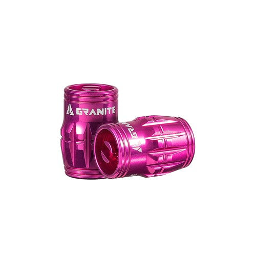 Two Granite Juicy pink metal valve cap containers with a textured design, perfect for your tubeless setup, are placed on a white background.