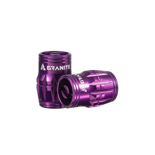 Two purple Granite Juicy Valve Caps with grooved cylindrical designs and branding are shown against a white background, designed for easy installation in a tubeless setup.
