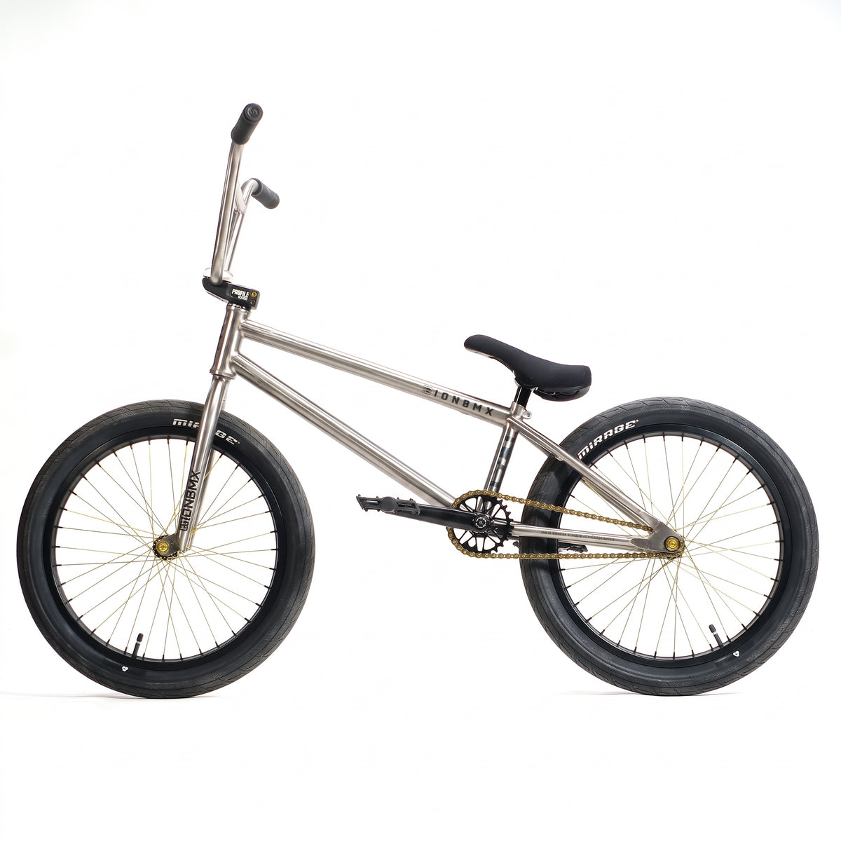 A side view of an ION BMX TiXX 20 Inch Bike featuring a silver frame, gold chain, and black tires, seat, and handlebars against a white background.
