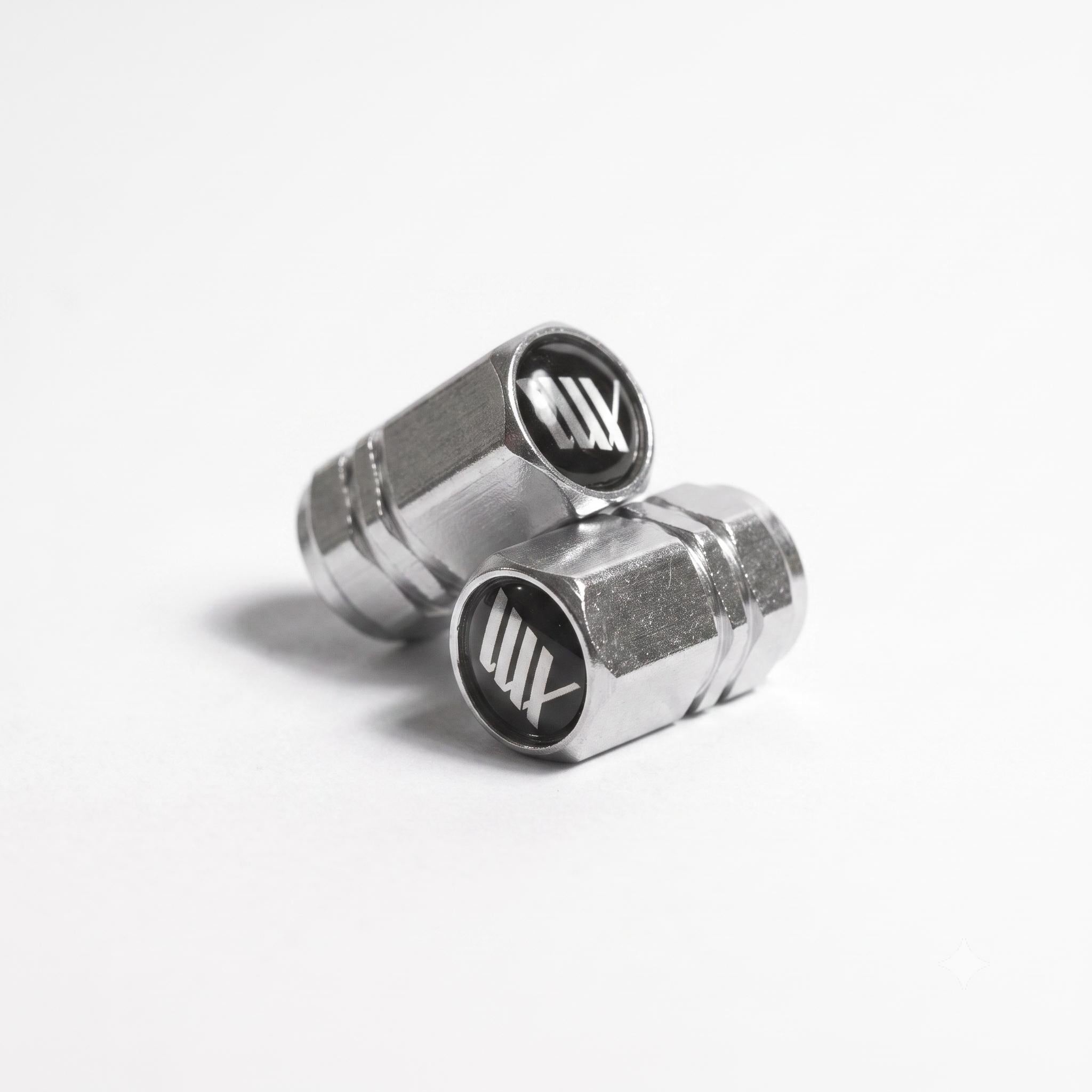 A pair of LUXBMX Hex Logo Alloy Valve Caps, each machined from alloy and featuring a black and white hex "LUXBMX" logo on top, displayed on a white background.