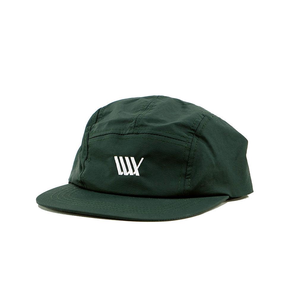 A LUXBMX Aero 5 Panel Cap - Dark Green with a white logo on it.