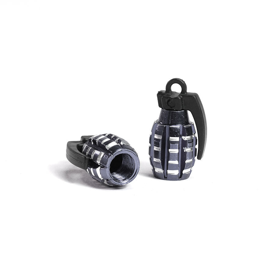 A pair of Grenade Valve Caps, featuring a miniature hand grenade design, with one cap upright and the other on its side to display its hollow interior.