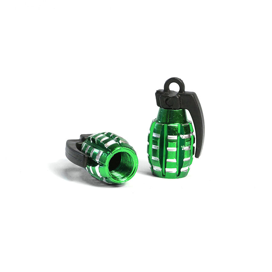 A pair of small, metallic green Grenade Valve Caps with black tops—one upright, one lying down to reveal its hollow interior. Sold as a set of two with Schrader Valve design—unique accessories for your wheels.