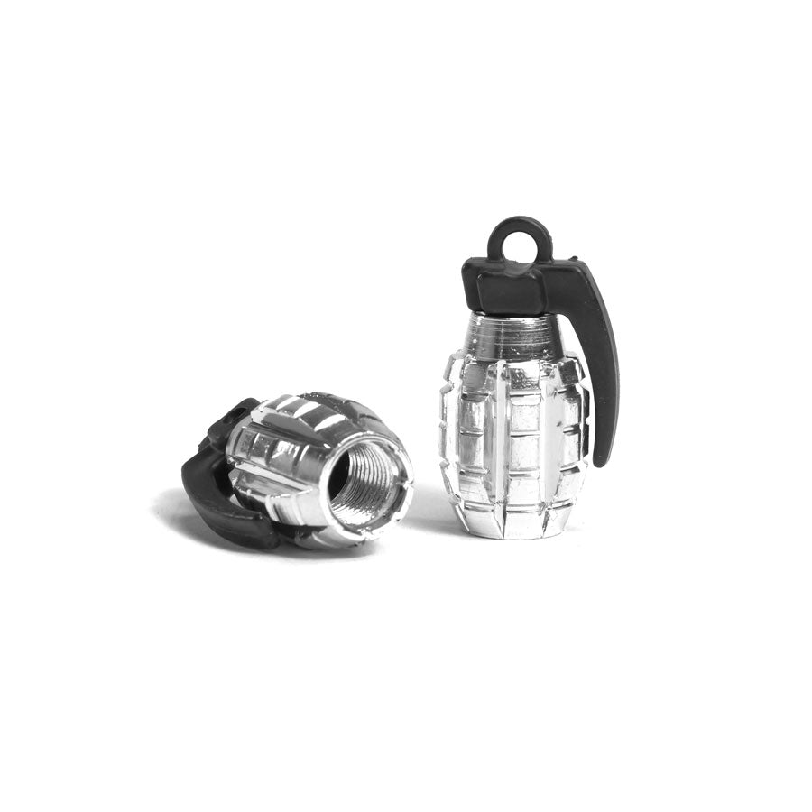 A pair of Grenade Valve Caps is displayed on a white background—one upright, the other on its side showing the threaded Schrader Valve opening.