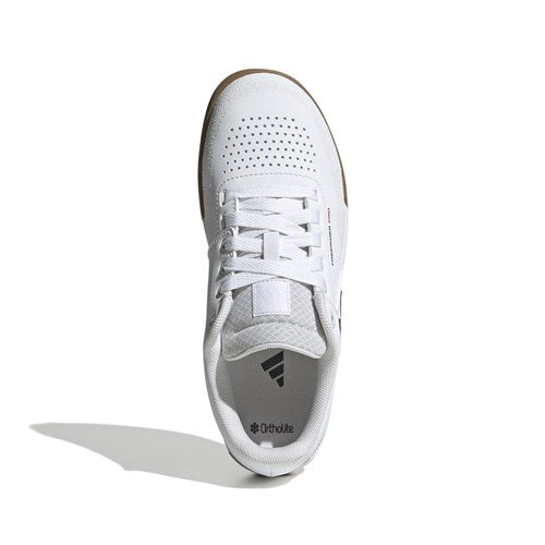 The Five Ten Freerider Pro Flat Core Shoes in white/core black/red, inspired by mountain bike shoes, feature perforated details, white laces, and a gum sole for pedal grip—shown top-down on a white background.