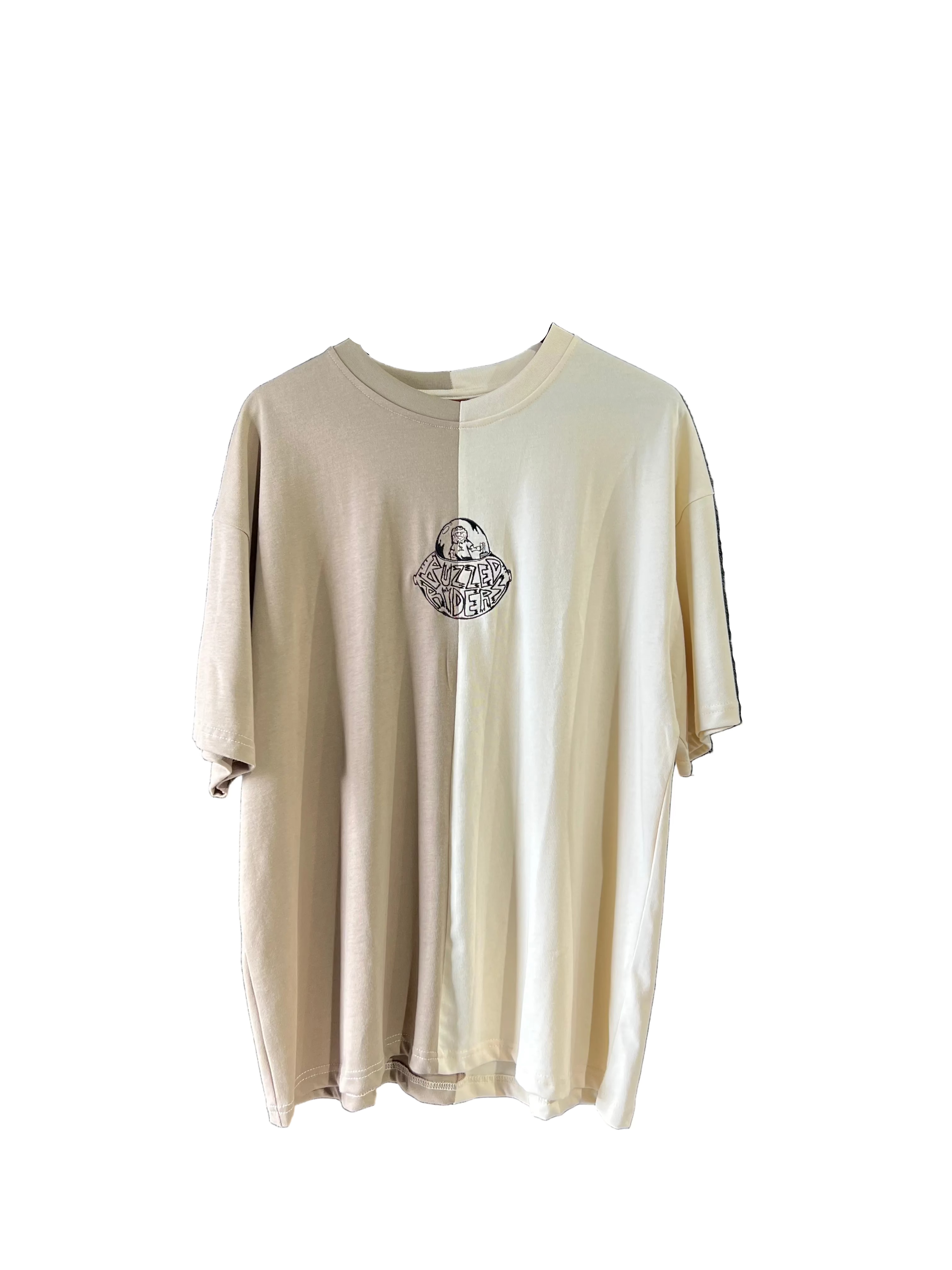 The Buzzed Riders Split Tee is a short-sleeve, two-tone top in beige and off-white, featuring a small circular graphic on the chest and shown against a plain white background—a perfect conversation starter for action sport enthusiasts.