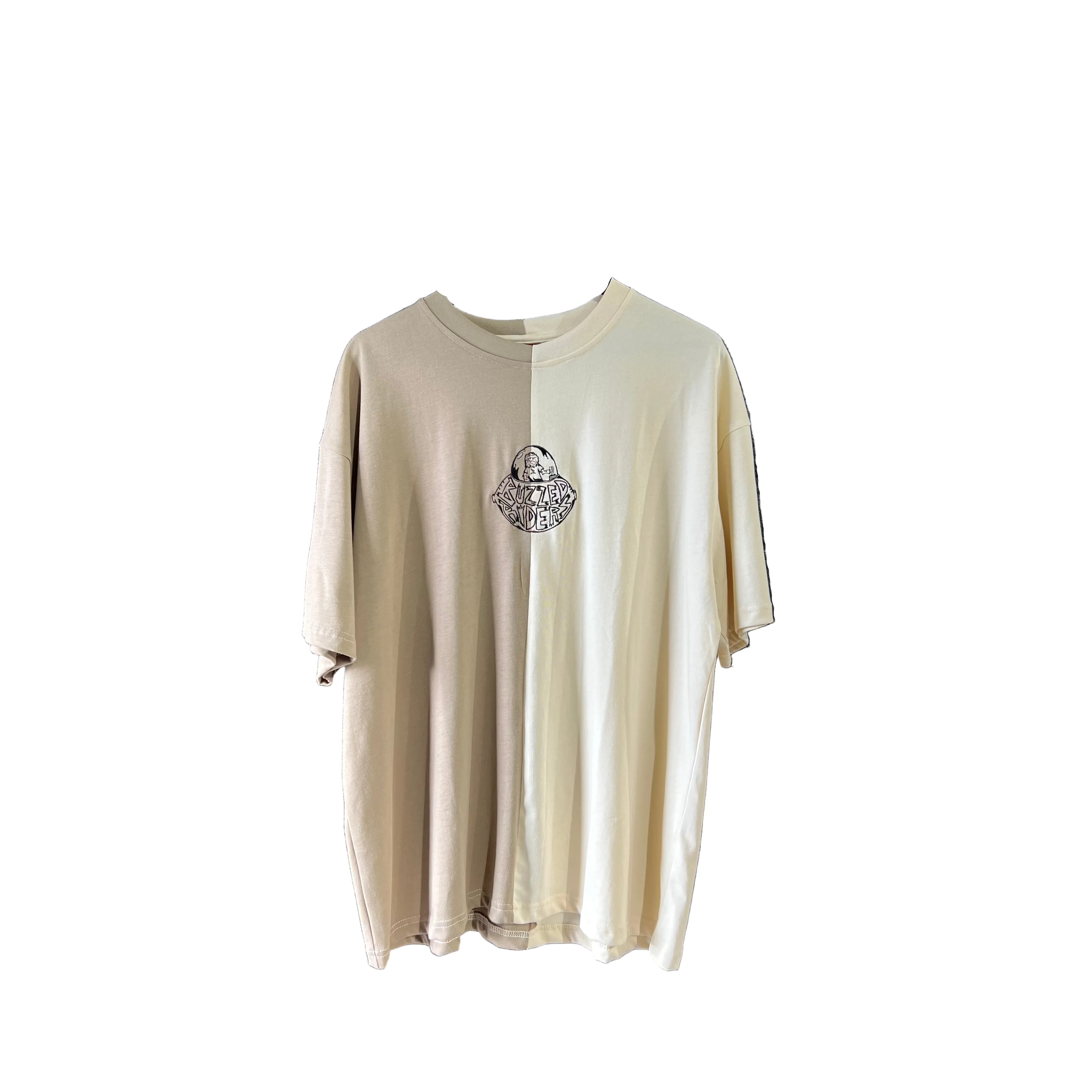 The Buzzed Riders Split Tee is a short-sleeve, two-tone top in beige and off-white, featuring a small circular graphic on the chest and shown against a plain white background—a perfect conversation starter for action sport enthusiasts.