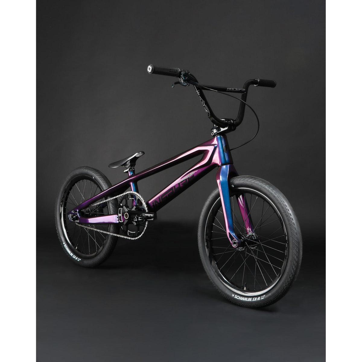 BMX racing bike featuring an Inspyre ERA Carbon Pro XXXXL frameset with a color-shifting purple and teal finish, black handlebars, and black wheels.