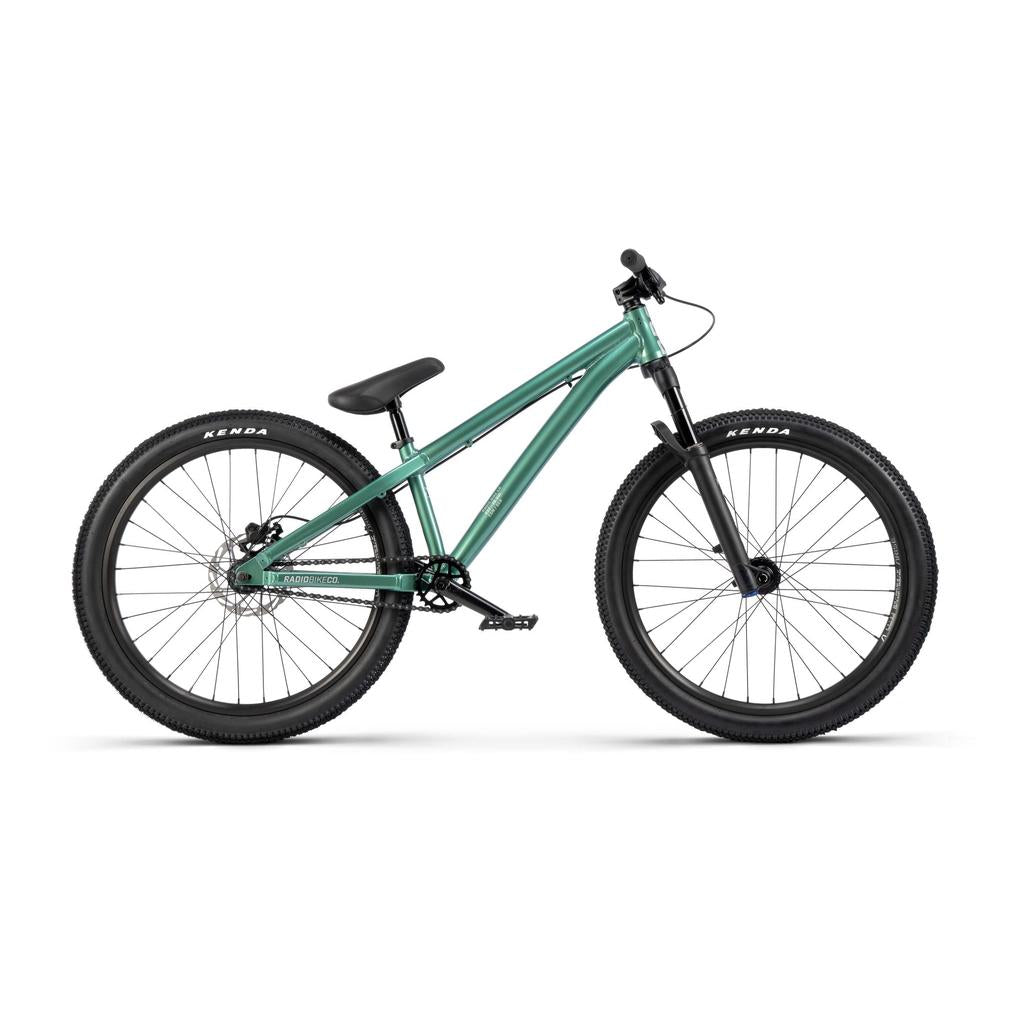 The Radio Griffin 24 Inch Dirt Jumper Bike is shown in side profile on a white background. It features a teal frame, single gear, front suspension fork, flat handlebars, and black Kenda tires.