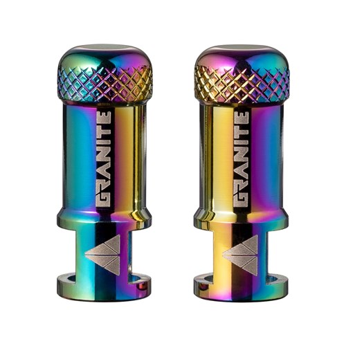 Two metallic, rainbow-colored Granite Juicy CNC Presta valve caps with “Granite” branding and textured tops, each ingeniously doubling as a valve core remover—displayed upright against a white background.