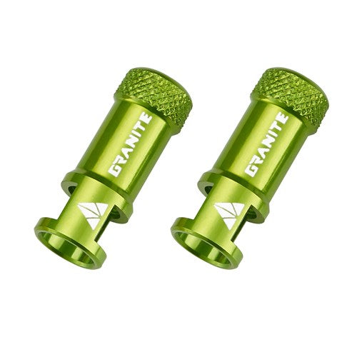 The Granite Juicy CNC Presta Valve Caps (Pair) are green metal bike accessories featuring “GRANITE” branding, textured grip ends, and an integrated valve core remover for added convenience. Shown against a white background.