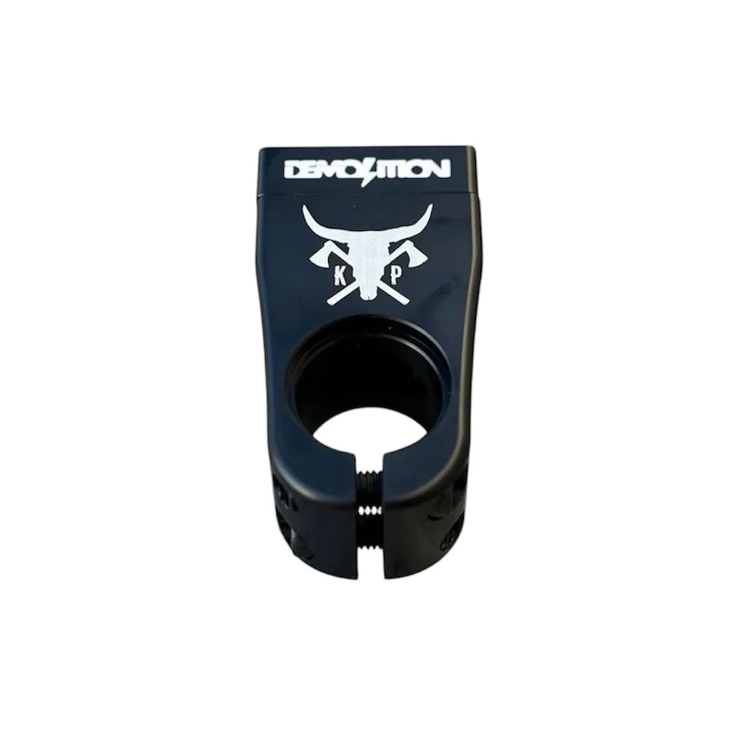 The Demolition Kevin Peraza Front Load Stem features a black design with "Demolition" and a bull skull graphic on top, along with "KP" initials, making it the perfect signature component for your BMX bike.