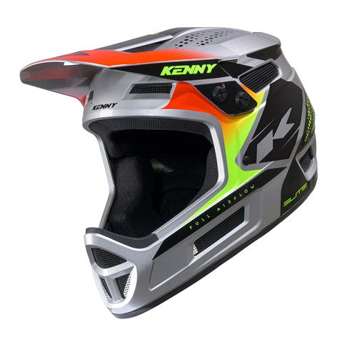 The Kenny Racing Helmet Elite Graphic Silver is a lightweight BMX helmet in gray, black, and neon yellow, featuring a visor and ventilation ports for optimal airflow. With the “Kenny” brand name displayed on the top and side, this helmet combines stylish design with excellent protection for riders.