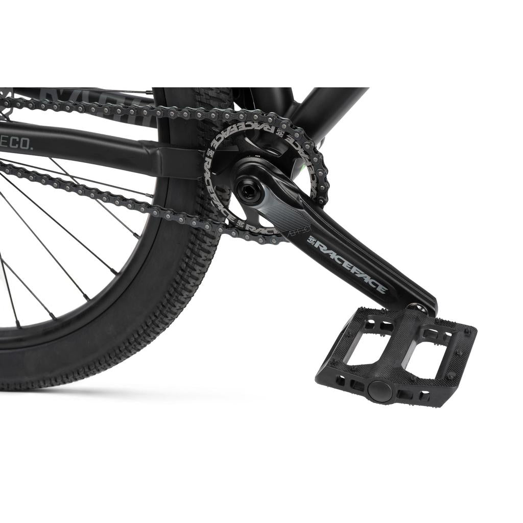 Close-up of the Radio 26 Inch Griffin Pro Bike’s rear wheel, chain, crank, and black Race Face pedal on its durable alloy frame set against a white background.